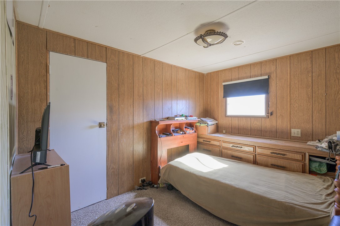 1798 Rio Grande Way Bullhead City, AZ 86442 - Photo 20 of 43 Bedroom with carpet and wood walls