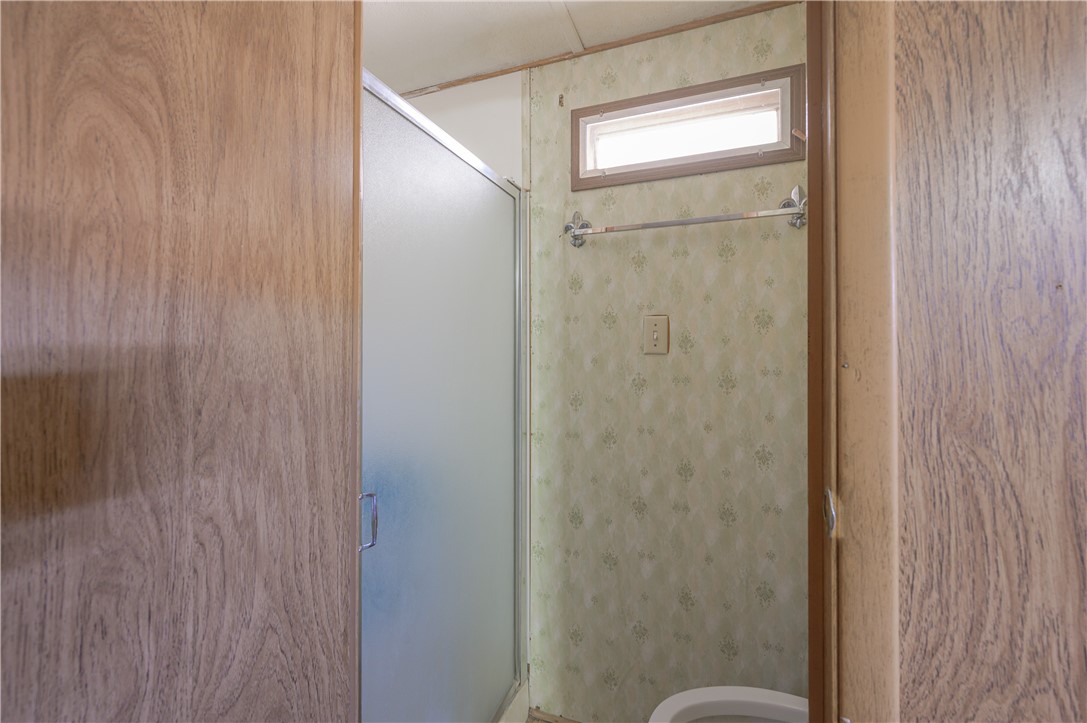 1798 Rio Grande Way Bullhead City, AZ 86442 - Photo 28 of 43 Bathroom featuring wallpapered walls and a shower stall