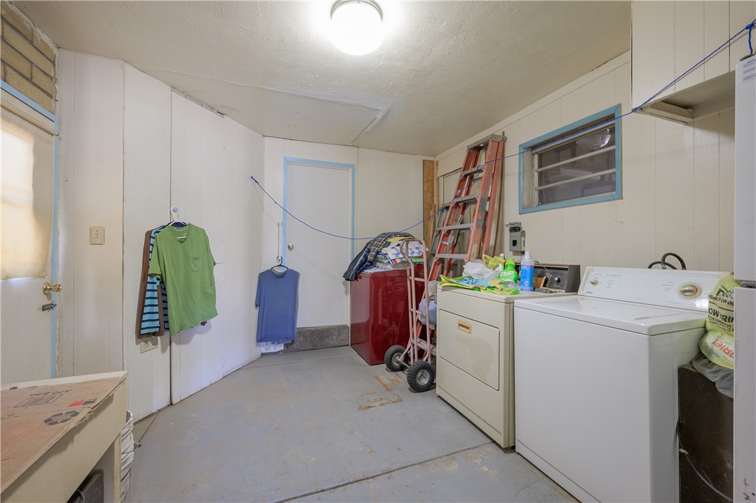 1798 Rio Grande Way Bullhead City, AZ 86442 - Photo 29 of 43 Laundry room with concrete flooring, washer and clothes dryer, and wooden walls