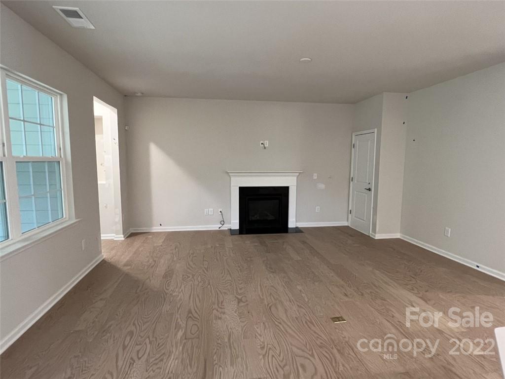 3159 Windhaven Lane, Unit 81 Tega Cay, SC 29708 - Photo 6 of 6 a view of empty room with wooden floor and fireplace