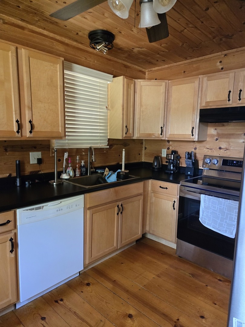 11 Cedar Lane Putnam, IL 61560 - Photo 5 of 16 a kitchen with stainless steel appliances granite countertop a sink a stove and cabinets