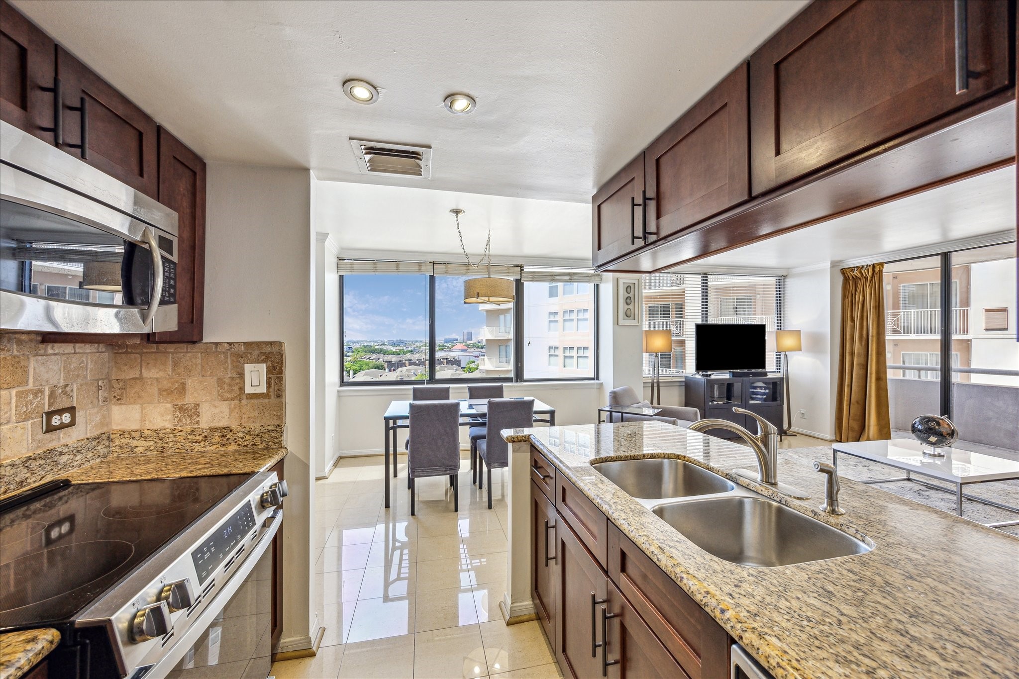 3525 Sage Road, Unit 1010 Houston, TX 77056 - Photo 12 of 34 View from the kitchen reveal the open dining and living areas—ideal for entertaining or relaxing in comfort.