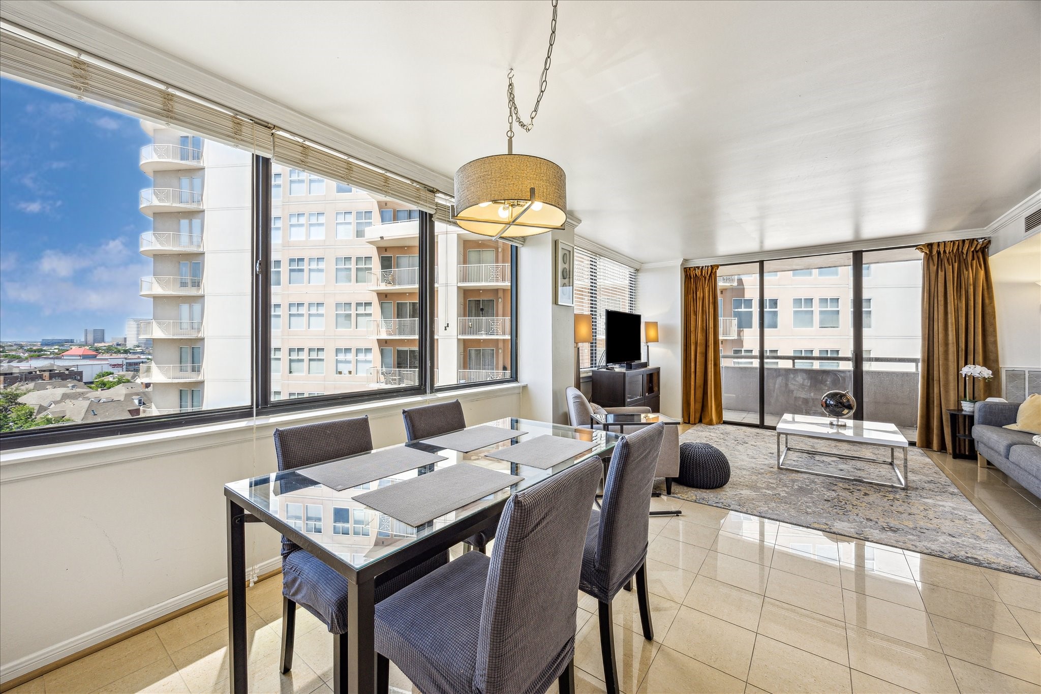 3525 Sage Road, Unit 1010 Houston, TX 77056 - Photo 2 of 34 Bright and airy view of the dining and living area, filled with natural light.