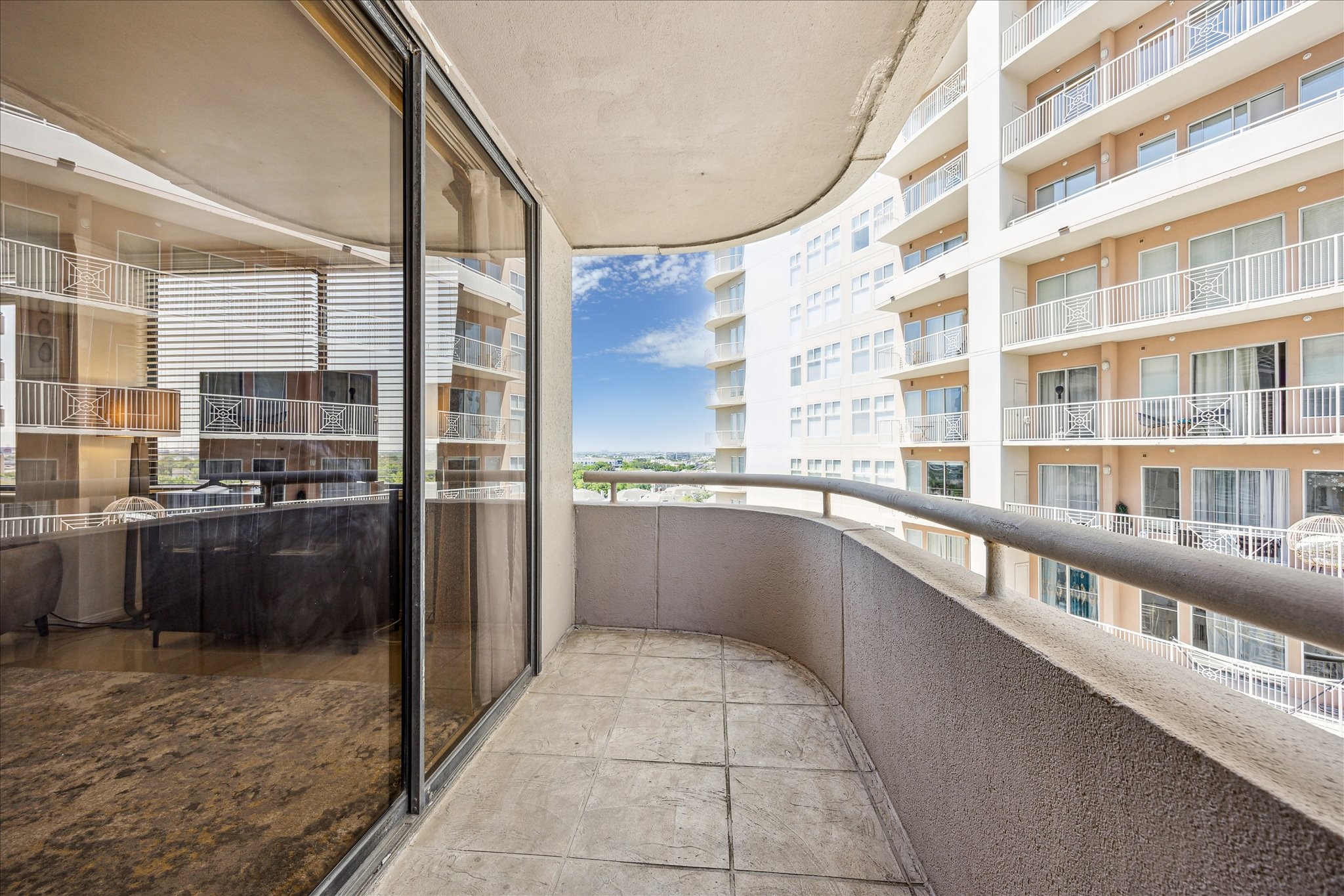 3525 Sage Road, Unit 1010 Houston, TX 77056 - Photo 10 of 34 Spacious balcony off the living room features sliding doors and is a perfect outdoor area to enjoy.