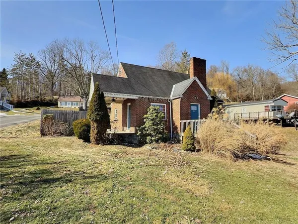 a view of a house with a yard covered in snow