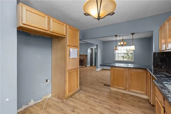 a view of a kitchen with a sink and cabinets