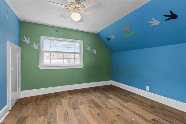 a view of a room with wooden floor and windows