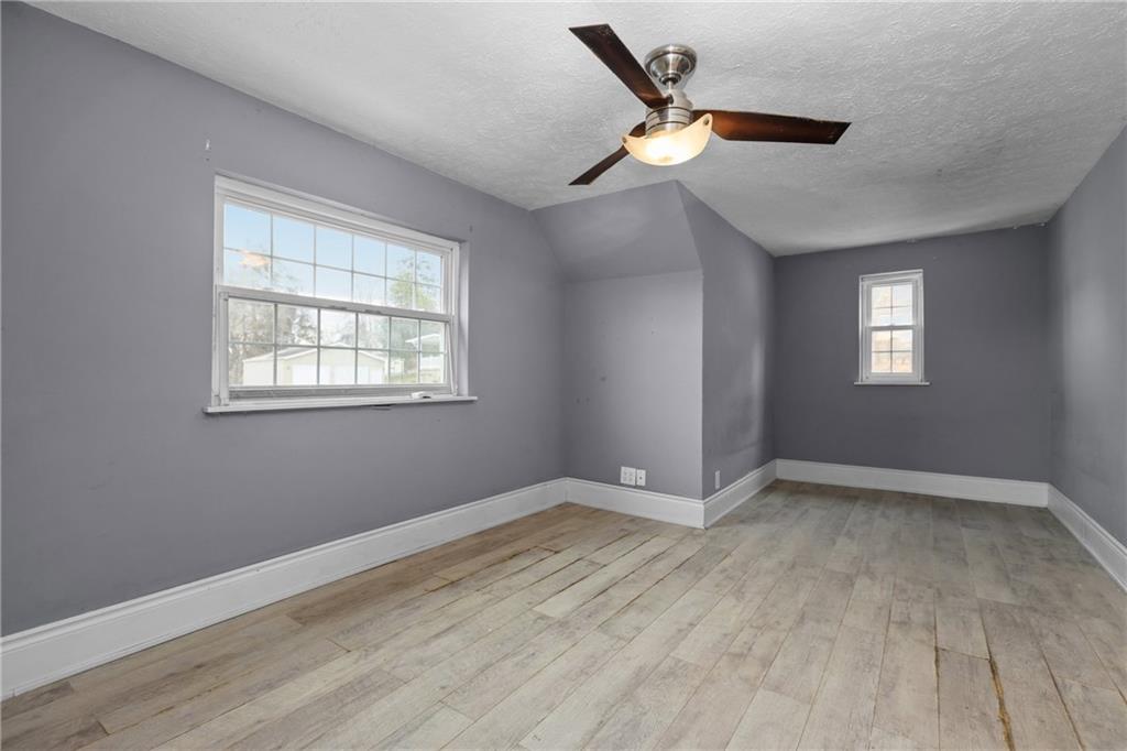 41 Bethlehem Street Fredericktown, PA 15333 - Photo 24 of 33 a view of an empty room with wooden floor and a window