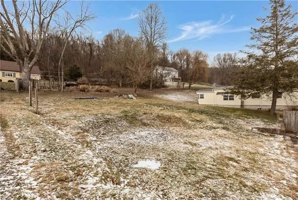 a view of a house with a wooden fence