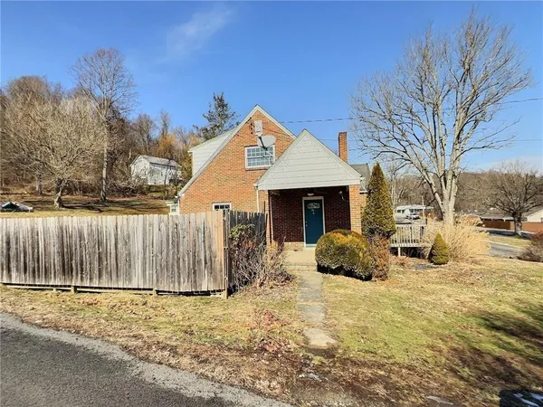 a view of a house with snow in front of house