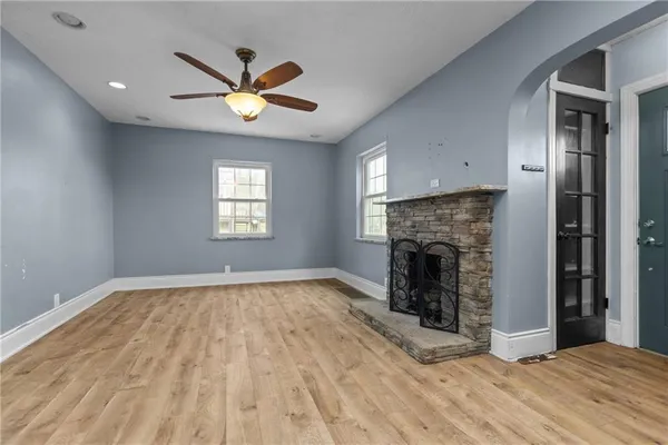 a view of empty room with fireplace and windows