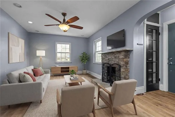a living room with furniture a fireplace and a flat screen tv