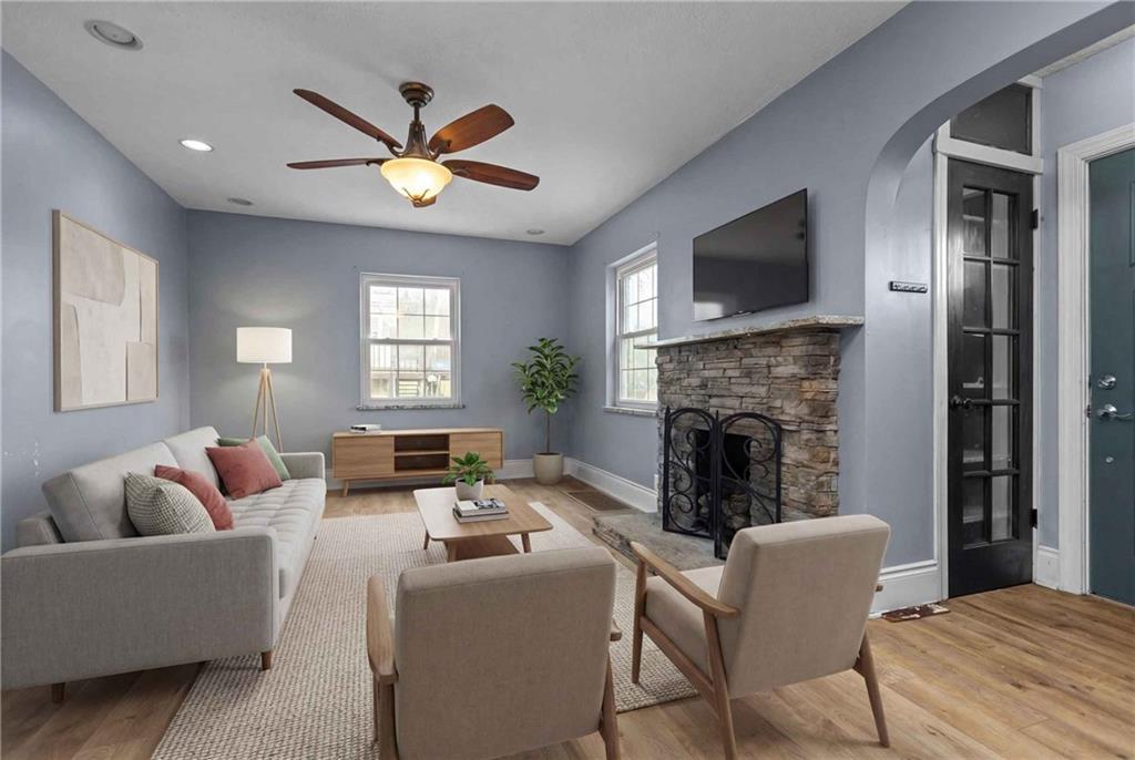 41 Bethlehem Street Fredericktown, PA 15333 - Photo 7 of 33 a living room with furniture a fireplace and a flat screen tv