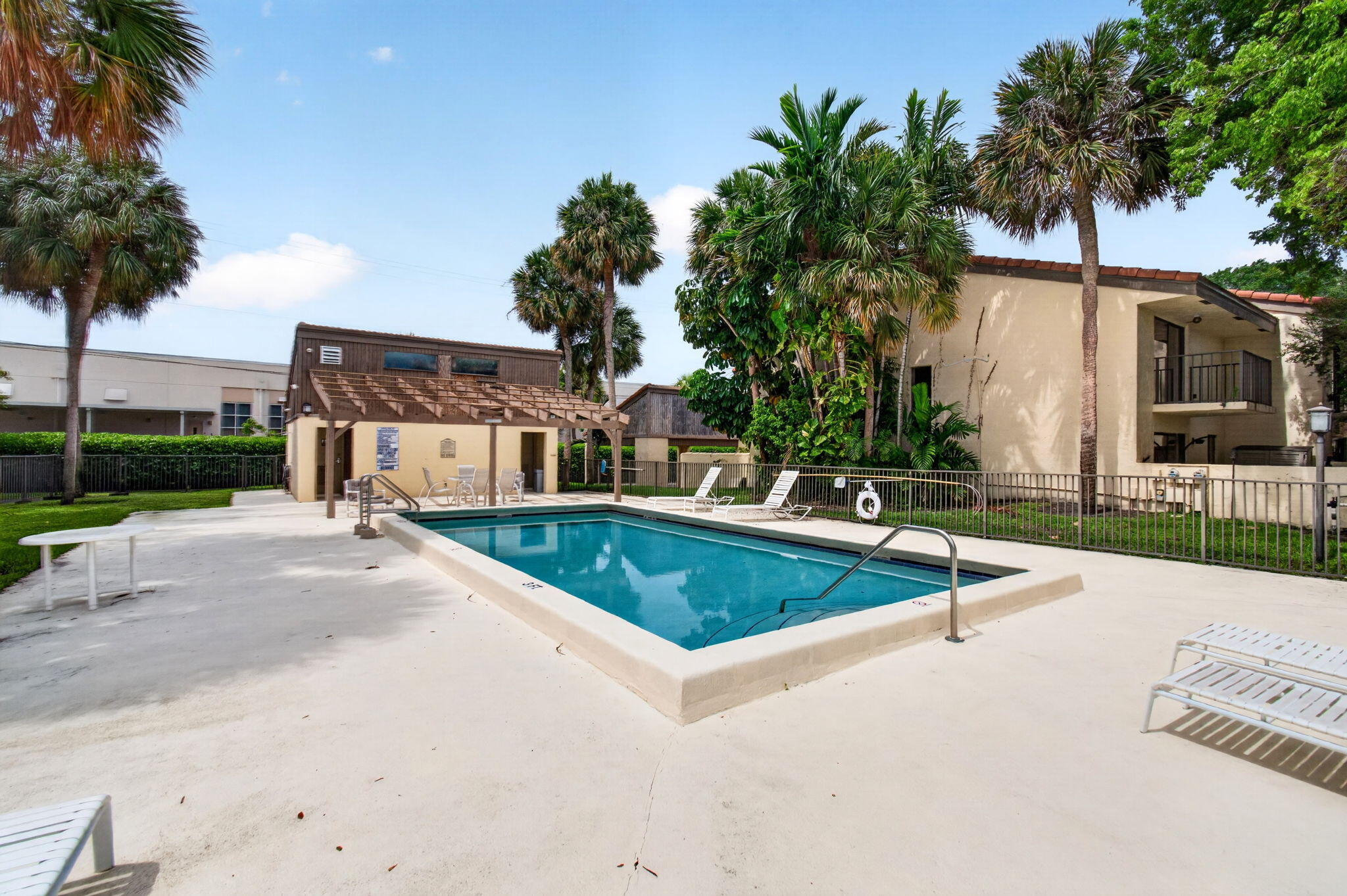 1330 Northwest 13th Street, Unit 12 Boca Raton, FL 33486 - Photo 52 of 52 a view of a house with swimming pool and a yard