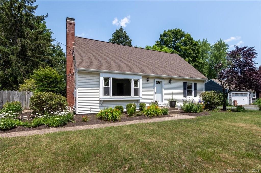 96 West Granby Road Granby, CT 06035 - Photo 1 of 1 a front view of a house with a garden