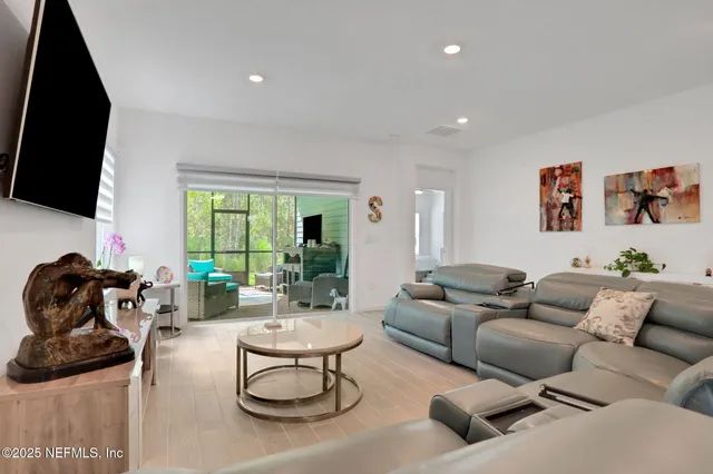 a bedroom with a bed a dresser and a flat screen tv