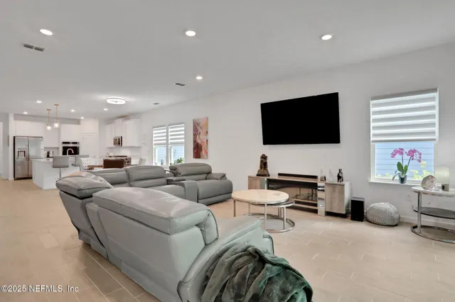 a spacious bedroom with a bed and a flat screen tv