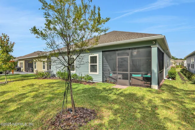 a aerial view of a house with swimming pool and ocean view