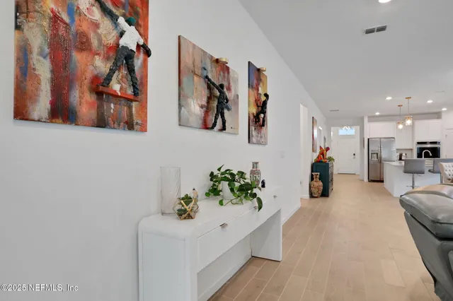 a kitchen with stainless steel appliances a refrigerator sink and microwave