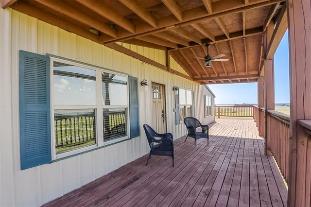 a view of outdoor space with wooden floor and windows