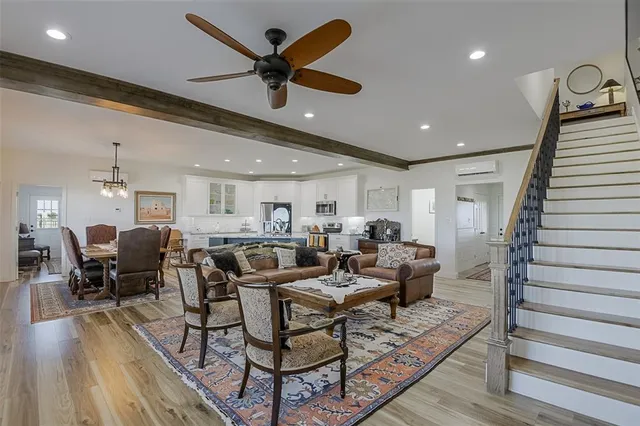 a living room with lots of furniture and wooden floor