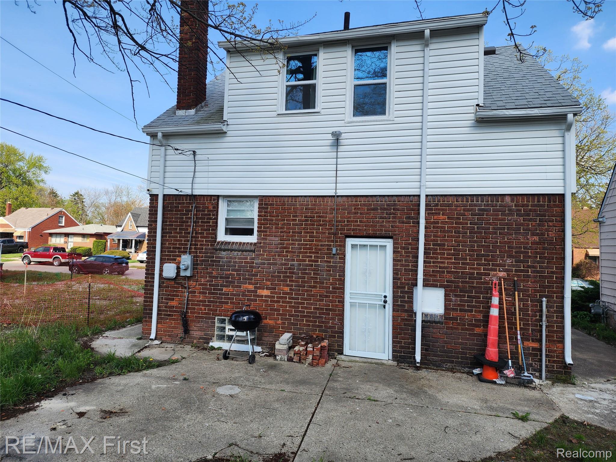 19345 Keystone Street Detroit, MI 48234 - Photo 13 of 15 Rear view of house with a chimney and brick siding