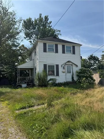 a front view of house with yard and green space
