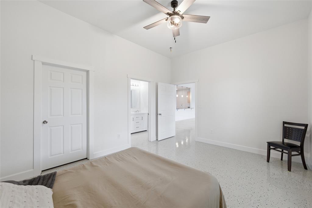151 Kasberg Road Leroy, TX 76691 - Photo 12 of 40 a spacious bedroom with a bed and a table