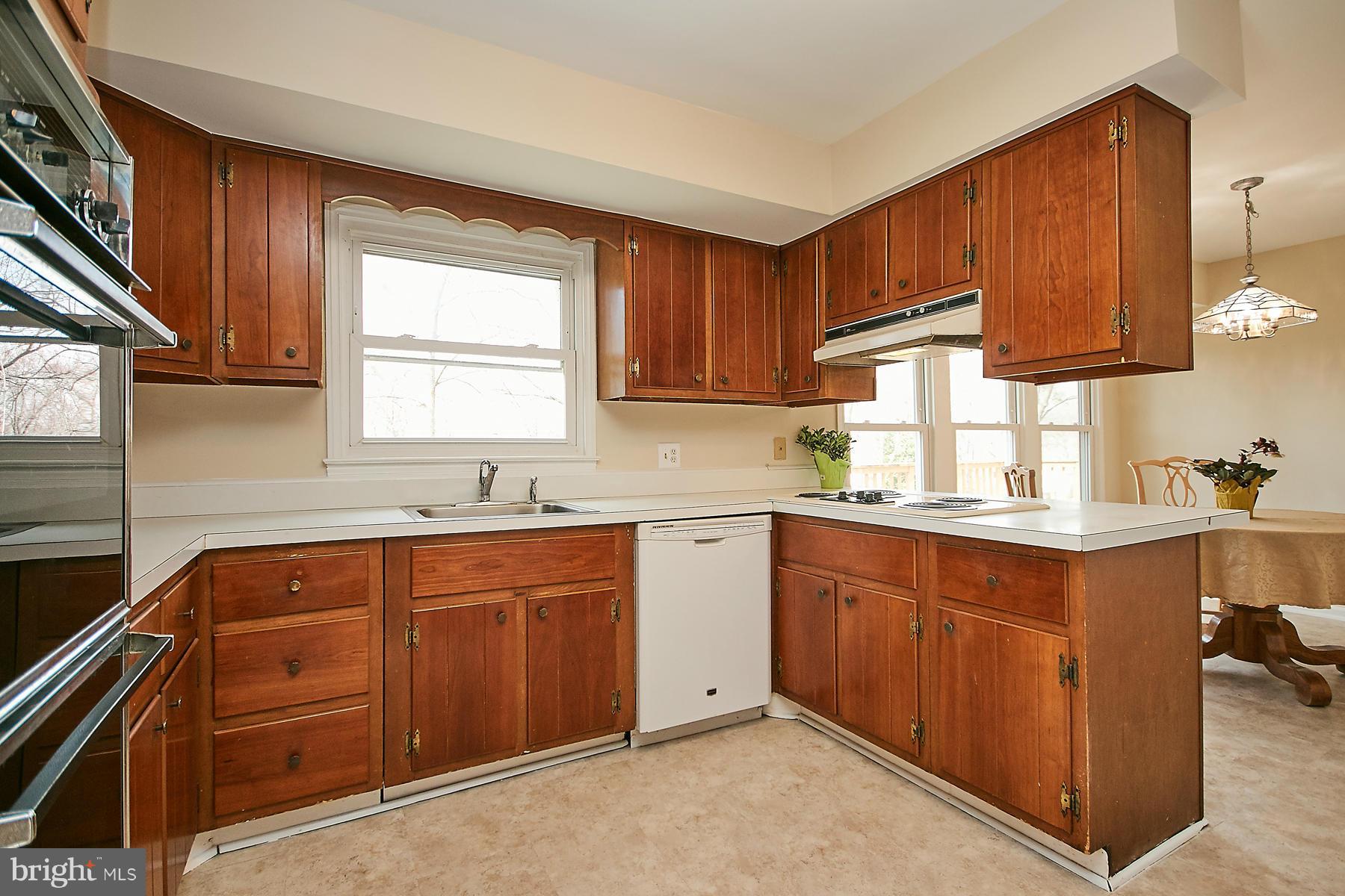1744 Lockerbie Lane Vienna, VA 22182 - Photo 11 of 30 a kitchen with a sink window and cabinets