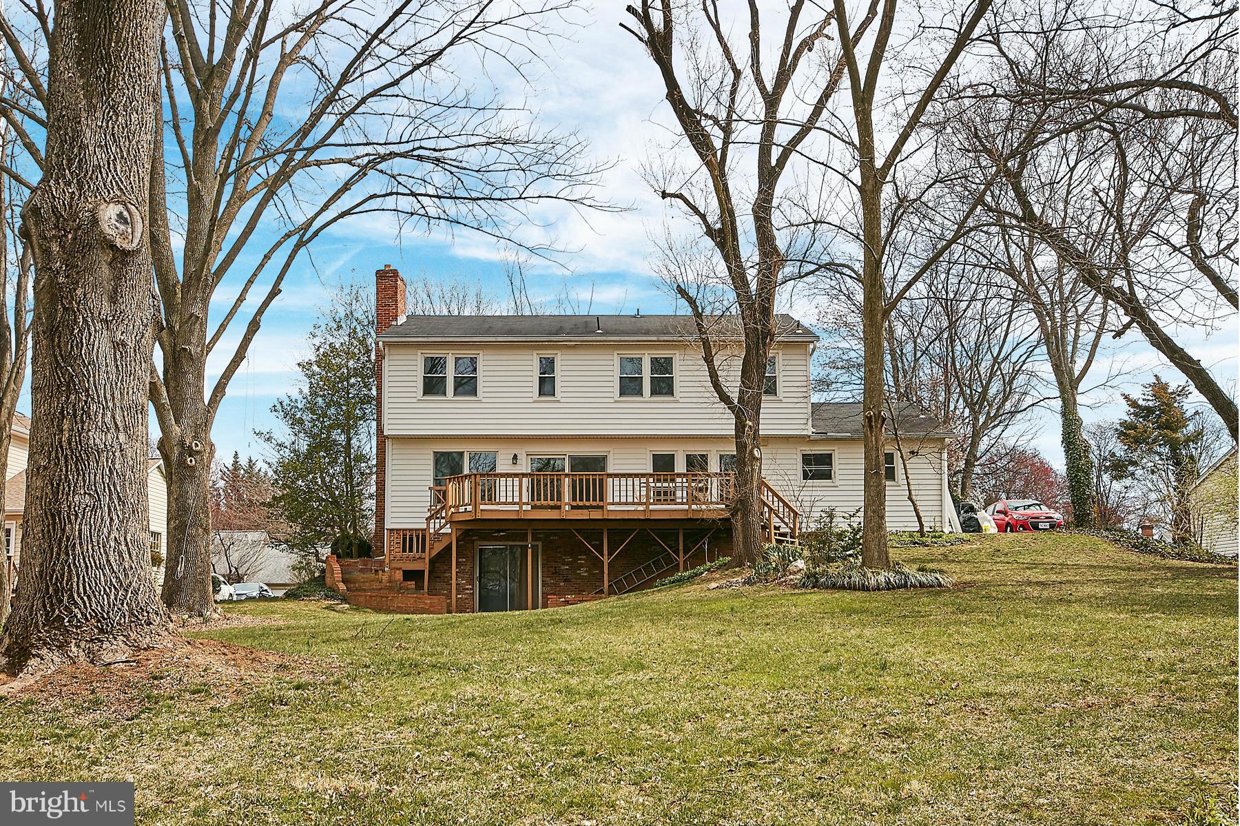 1744 Lockerbie Lane Vienna, VA 22182 - Photo 3 of 30 a view of a house with a large tree and a yard