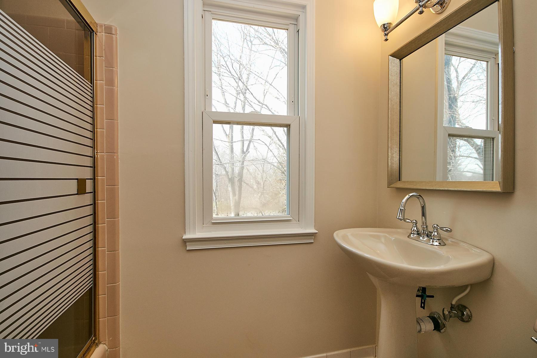 1744 Lockerbie Lane Vienna, VA 22182 - Photo 24 of 30 a bathroom with a sink a mirror and a window
