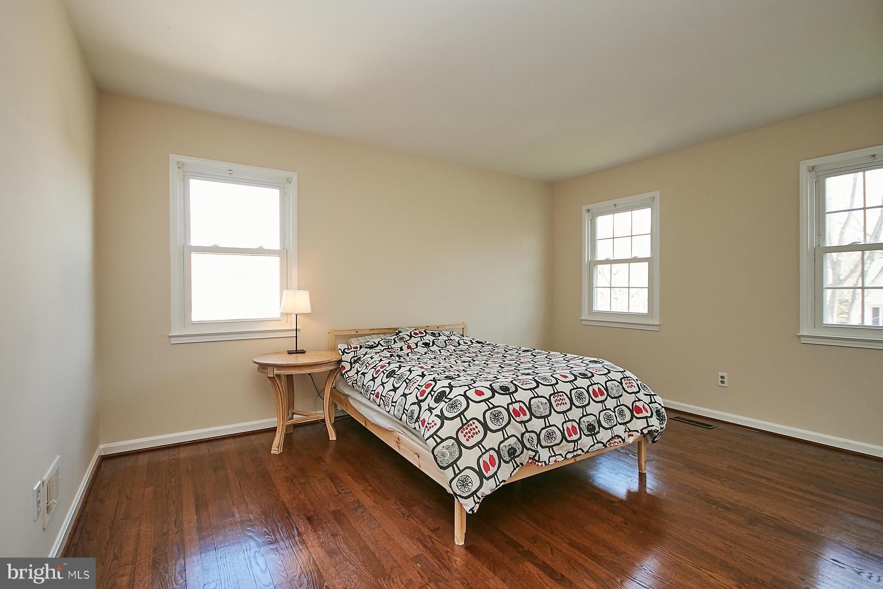 1744 Lockerbie Lane Vienna, VA 22182 - Photo 25 of 30 a bedroom with a bed and wooden floor