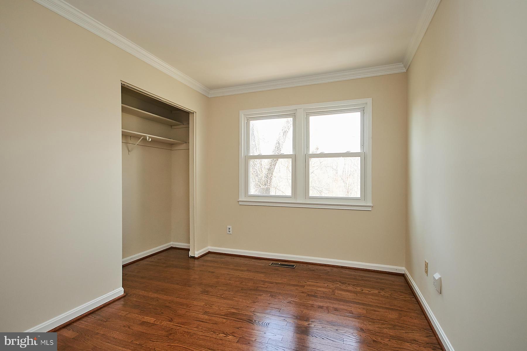 1744 Lockerbie Lane Vienna, VA 22182 - Photo 26 of 30 an empty room with wooden floor and windows