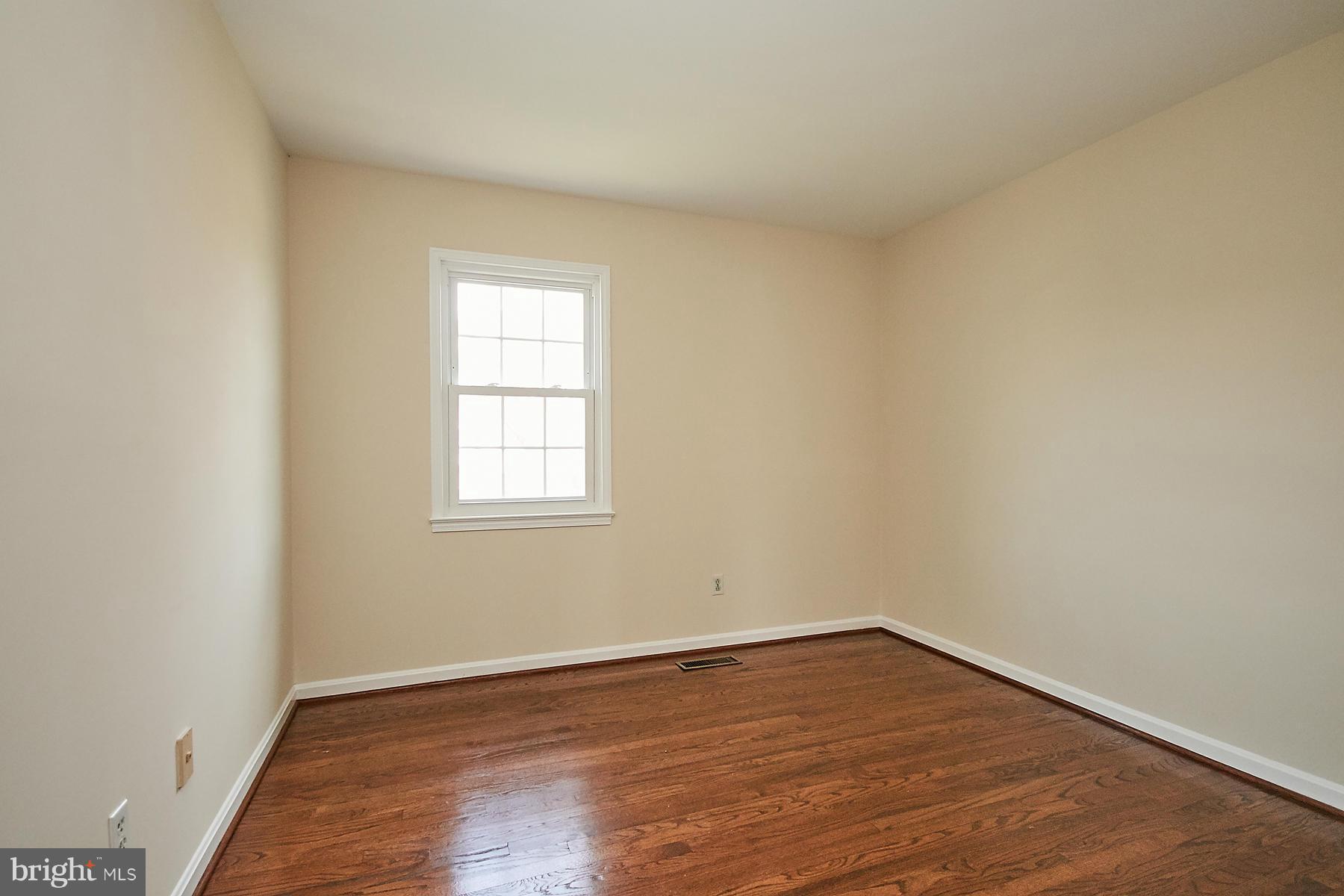 1744 Lockerbie Lane Vienna, VA 22182 - Photo 27 of 30 wooden floor in an empty room with a window
