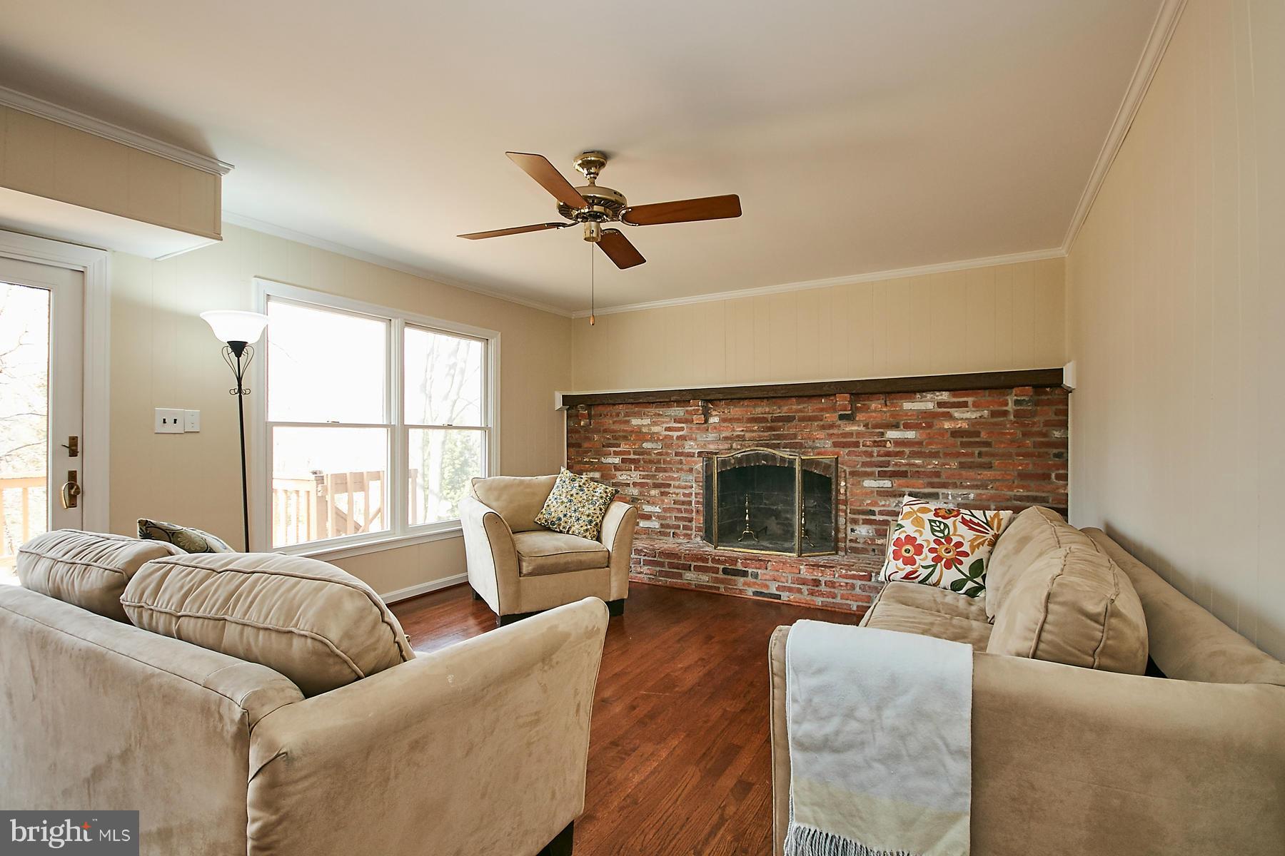 1744 Lockerbie Lane Vienna, VA 22182 - Photo 7 of 30 a living room with furniture fireplace and a large window