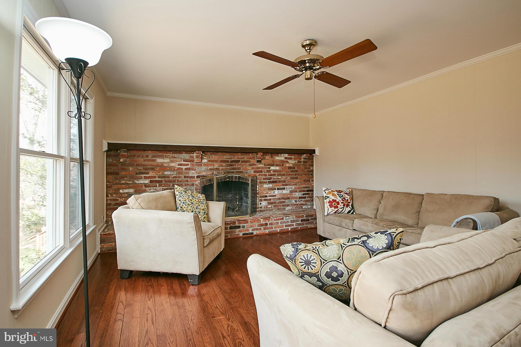 1744 Lockerbie Lane Vienna, VA 22182 - Photo 8 of 30 a living room with furniture and a fireplace