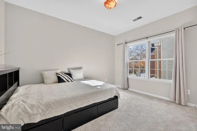 a bedroom with a bed and with furniture