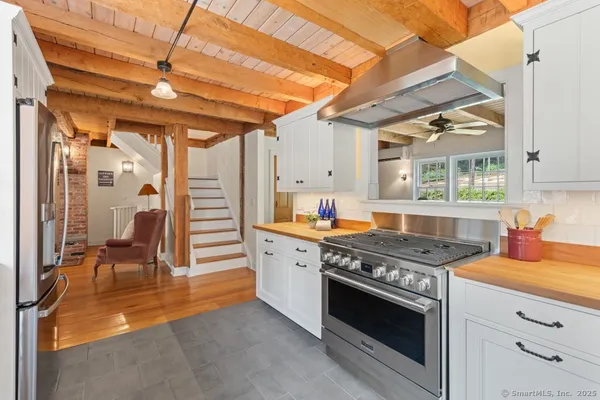a kitchen with stainless steel appliances granite countertop a stove a sink and a refrigerator