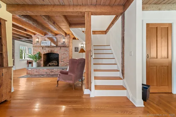 a view of entryway and hall with wooden floor