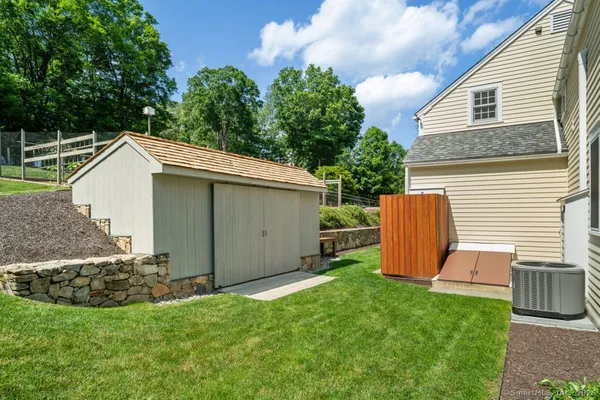 a view of backyard with barbeque grill and potted plants