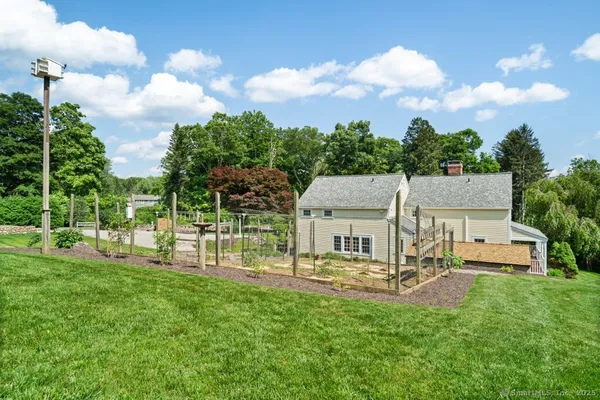 a view of a house with backyard and porch