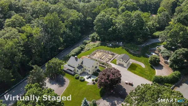 an aerial view of a house with a yard and garden