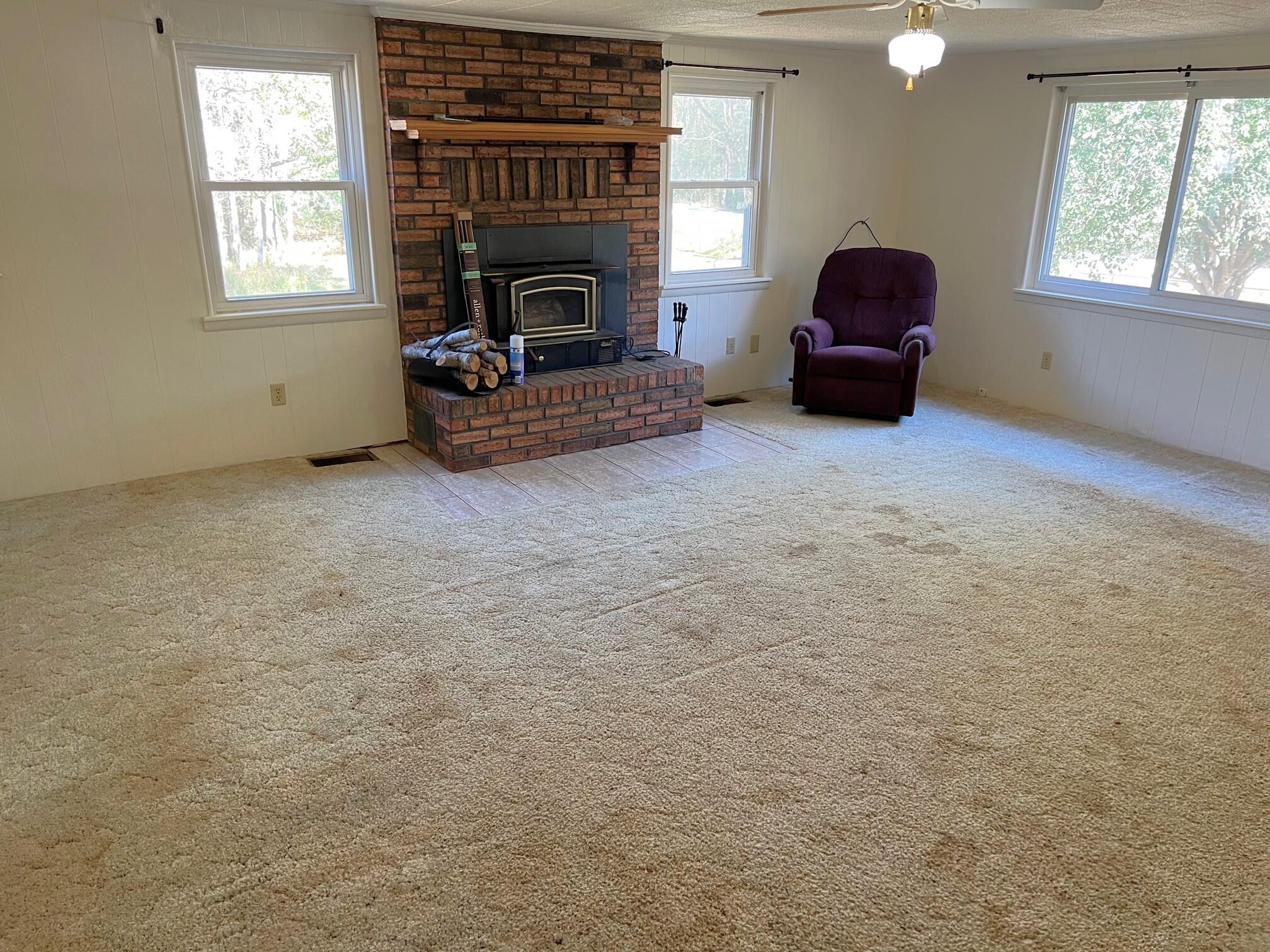 401 Mims Road DeFuniak Springs, FL 32433 - Photo 19 of 78 a living room with furniture a window and a fireplace