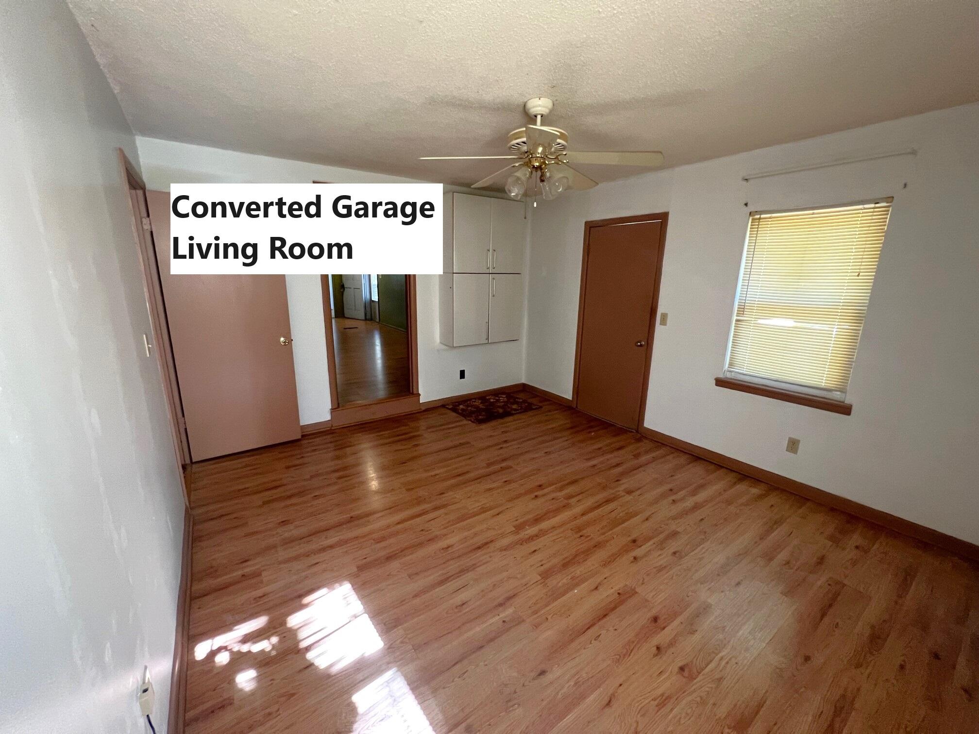 401 Mims Road DeFuniak Springs, FL 32433 - Photo 24 of 78 an empty room with wooden floor and windows