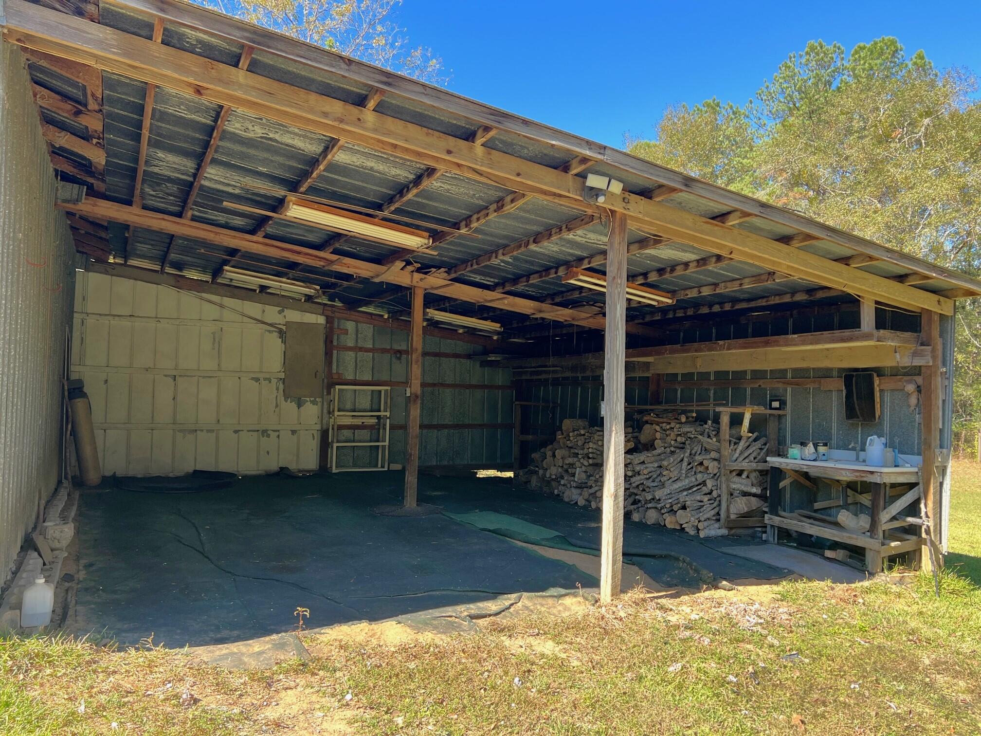 401 Mims Road DeFuniak Springs, FL 32433 - Photo 3 of 78 a view of a room with wooden walls