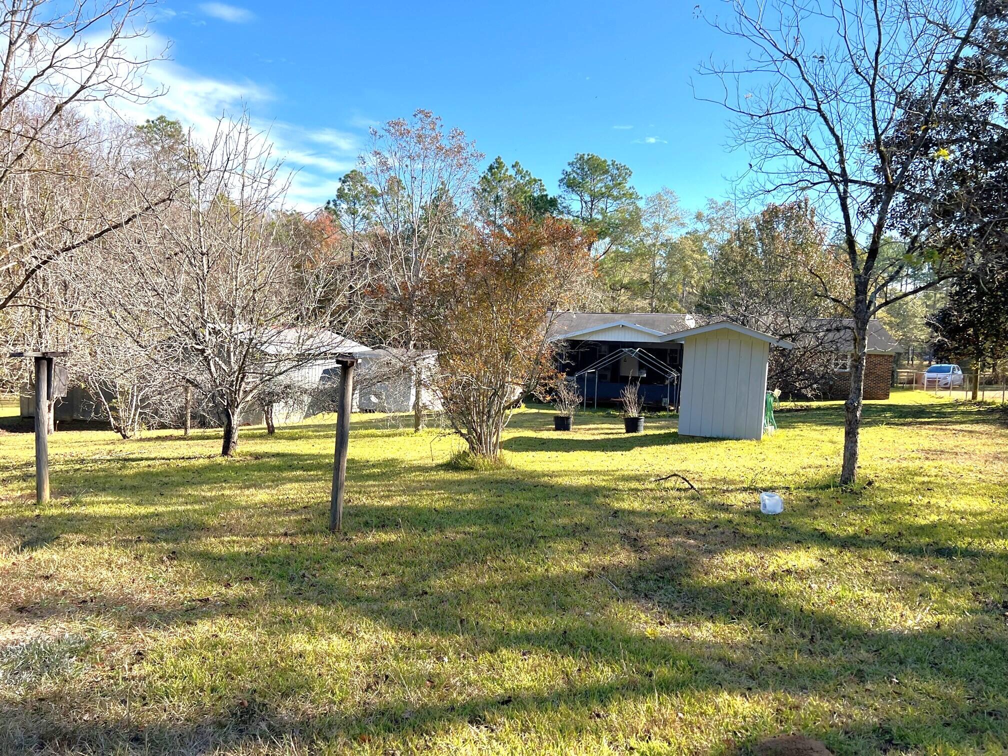 401 Mims Road DeFuniak Springs, FL 32433 - Photo 50 of 78 a swimming pool with outdoor seating and yard