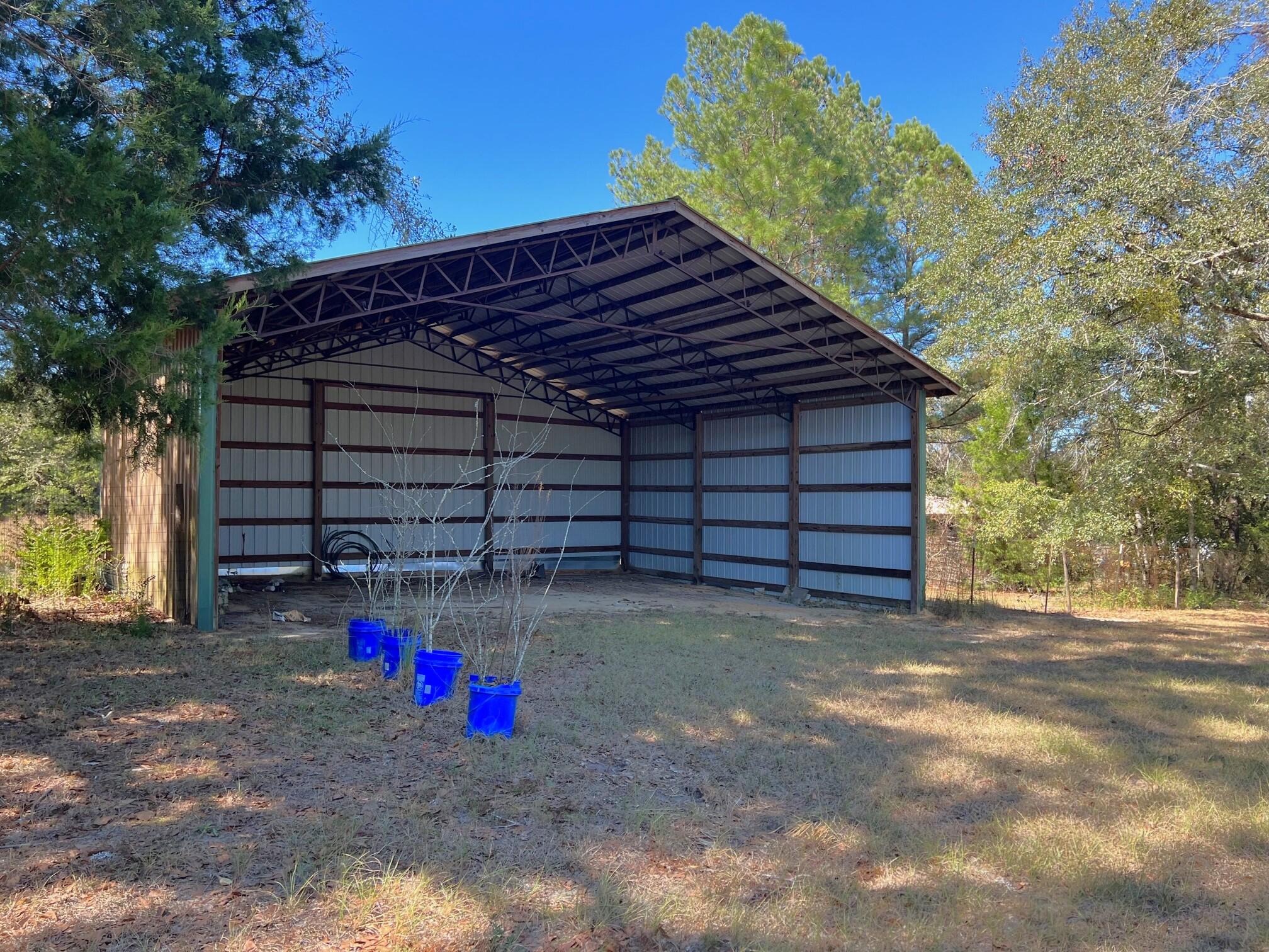 401 Mims Road DeFuniak Springs, FL 32433 - Photo 5 of 78 a view of a house with a small yard and potted plants