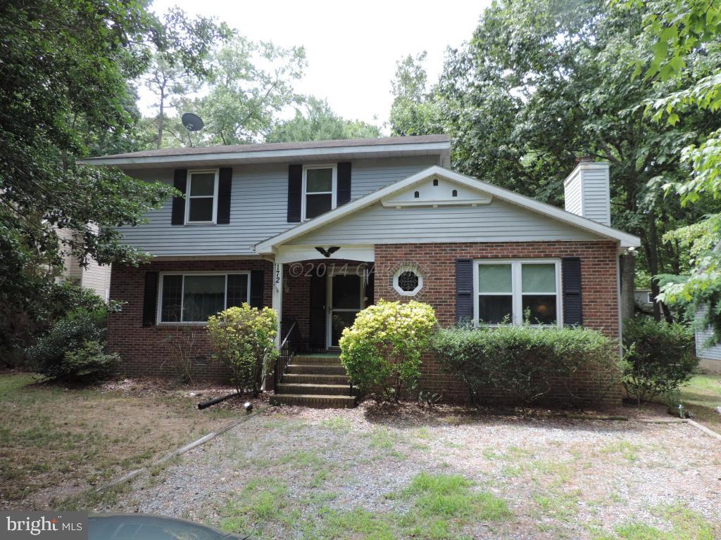 172 Windjammer Road Ocean Pines, MD 21811 - Photo 1 of 24 a front view of house with yard and trees around