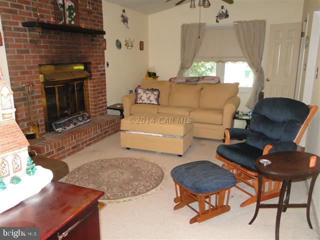 172 Windjammer Road Ocean Pines, MD 21811 - Photo 3 of 24 a living room with furniture and a fireplace