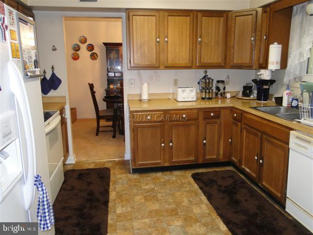 172 Windjammer Road Ocean Pines, MD 21811 - Photo 5 of 24 a kitchen with stainless steel appliances granite countertop a stove a sink and a refrigerator